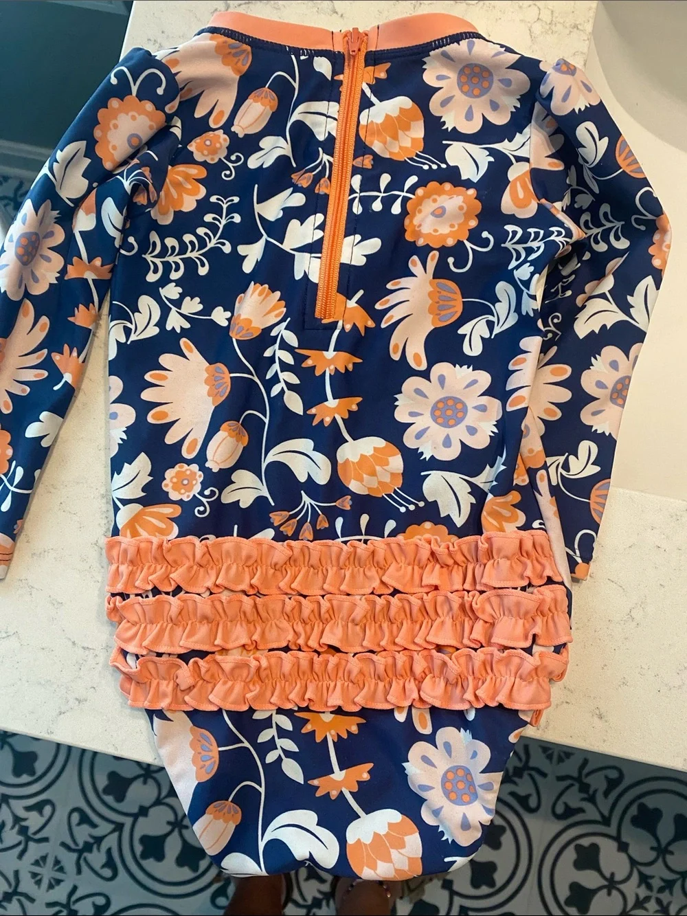 Ruffle Butts Navy Swimsuit with Peach Floral Accents